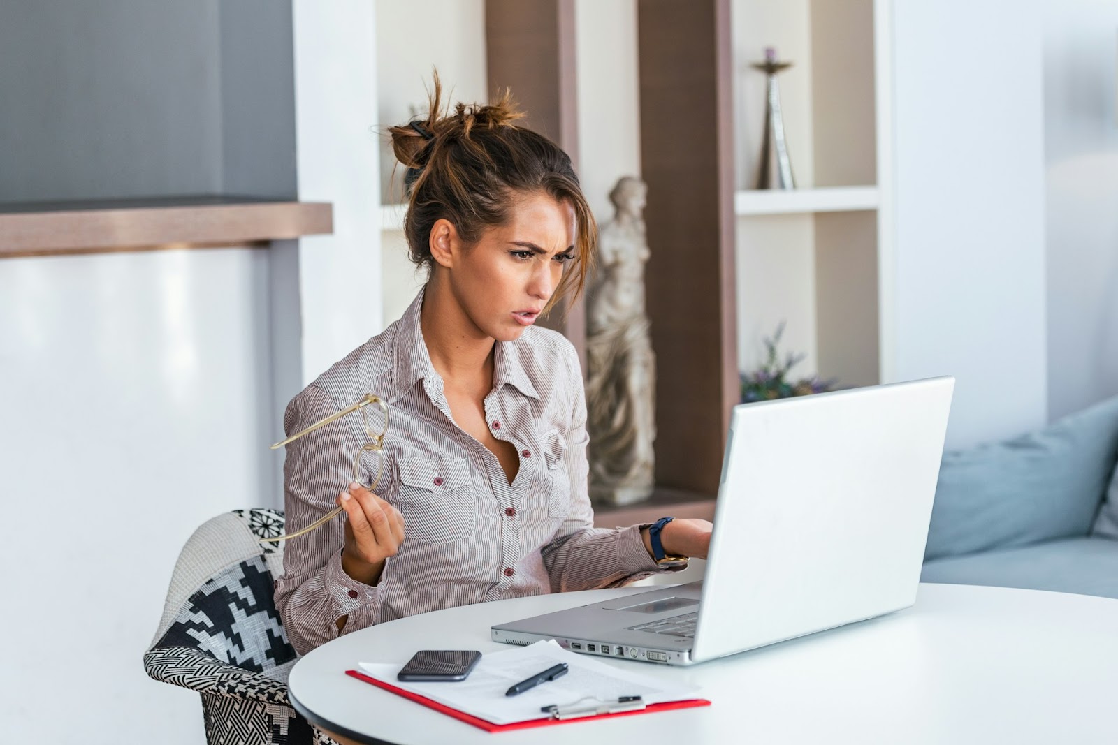 An angry-looking female developer sat at her laptop