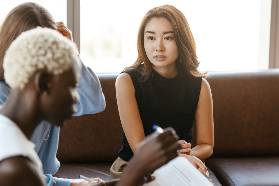 Women of colour in casual dress discussing poor management